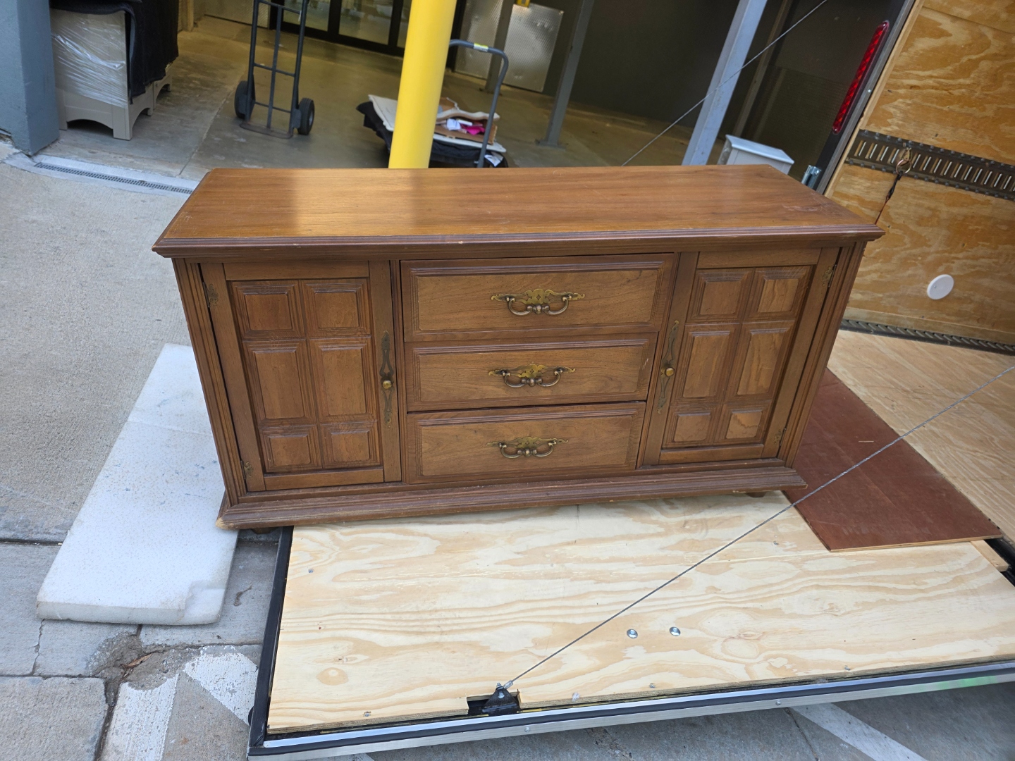 Vintage Credenza — Paneled cabinet doors · three center drawers · brass bail pulls